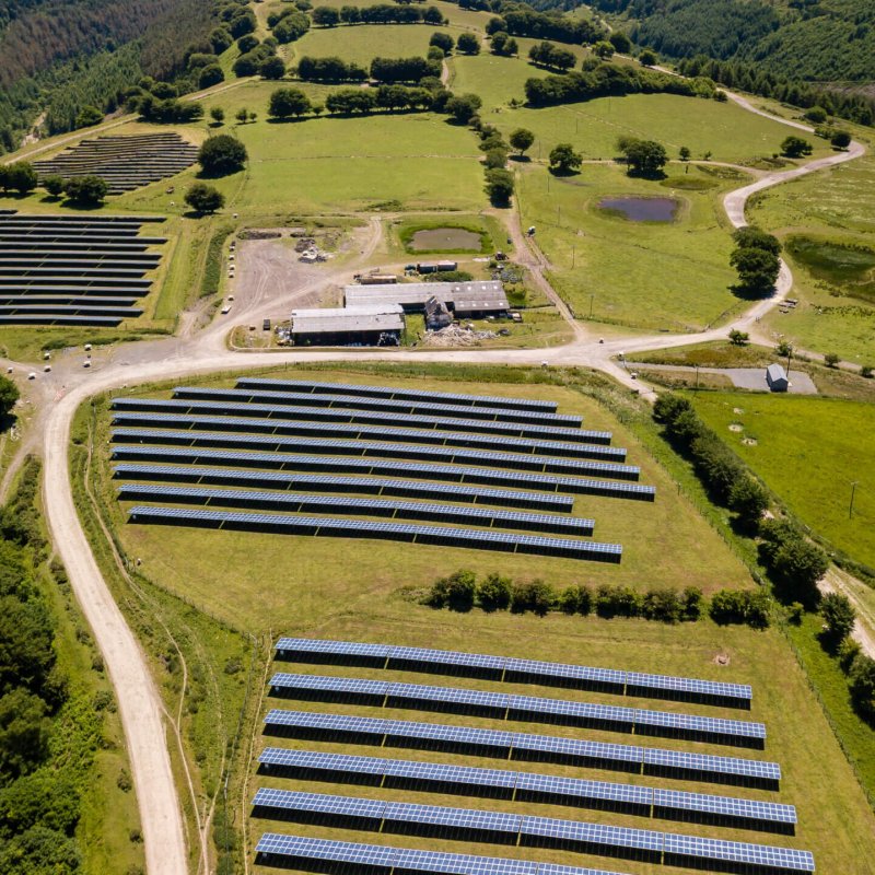 Aerial drone view of a solar energy farm on a mountainside (South Wales)